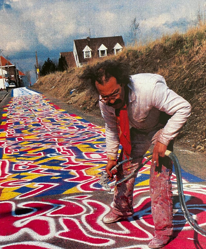 Mahjoub Ben Bella in Paris painting 'L'Envers du Nord' using the roadway for Paris-Roubaix in 1986. Nadjib Ben Bella