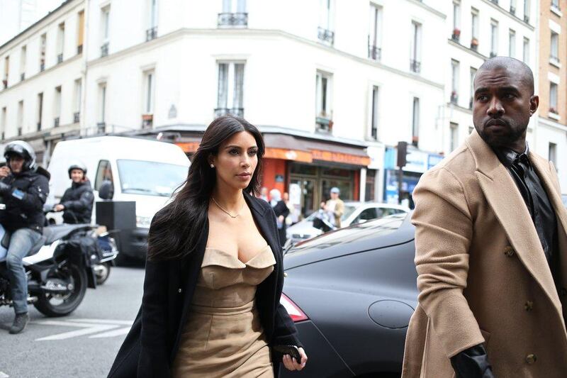 Kanye West and Kim Kardashian stroll through rue Darboy in the 11th district near Belleville as they shop on May 21, 2014 in Paris. The celebrity pair is expected to be tying the knot this weekend, fuelling speculation about the wedding’s location. Florence’s La Nazione daily reported that they would have a marriage ceremony in France early on May 24, before travelling to Italy for the party. Kenzo Tribouillard / AFP photo