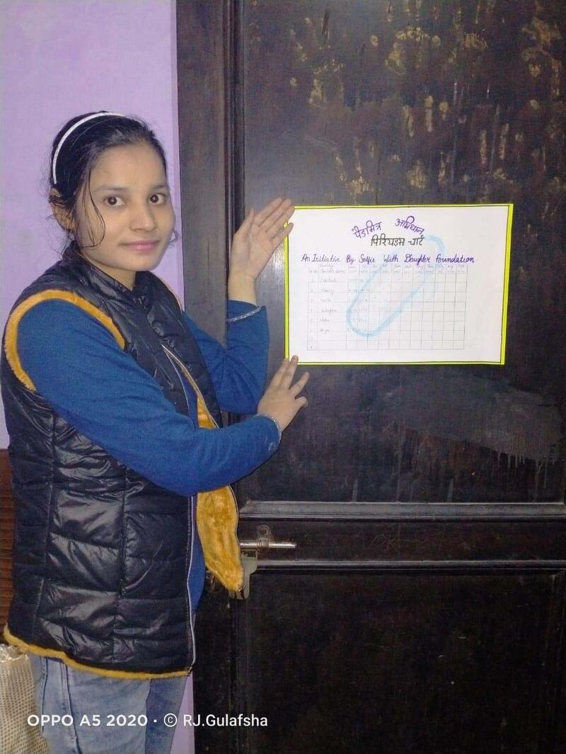 Monika holds the Period Chart that she has put up at her home in Haryana.The chart is an initiative by Sunil Jaglan, a social worker to raise awareness about menstrual health.