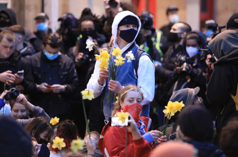 Some demonstrators held placards and flowers during the protest. EPA