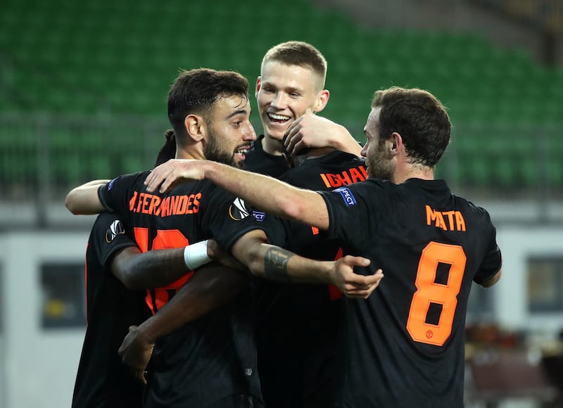 Bruno Fernandes and other Manchester United players celebrate with Odion Ighalo after his goal against LASK in the Europa League. Getty Images
