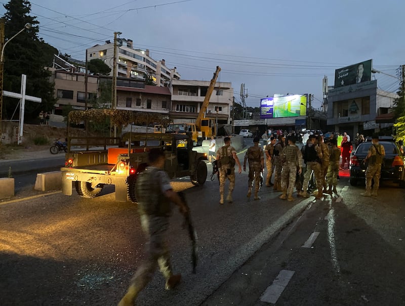 Lebanese army members gather near the overturned lorry. Reuters