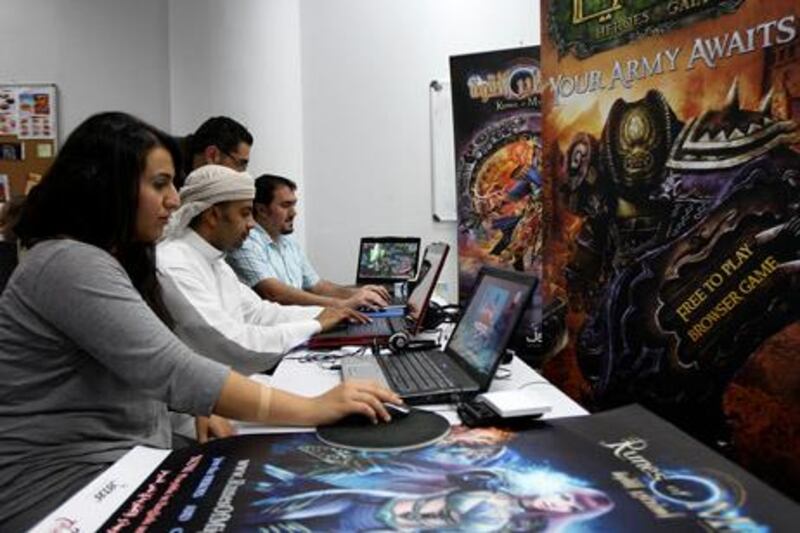 

DUBAI, UNITED ARAB EMIRATES Ð Oct 26: Left to Right- Marwa Mahallati, Masoud Ali and Samer Batmani from marketing team working on the online games in arabic at Tahadi office in Internet City in Dubai. (Pawan Singh / The National) For News. Story by Martin Croucher 
