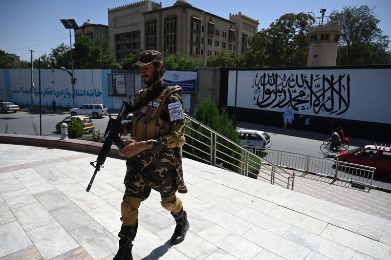 A Taliban fighter stands guard outside the US embassy in Afghanistan. AFP