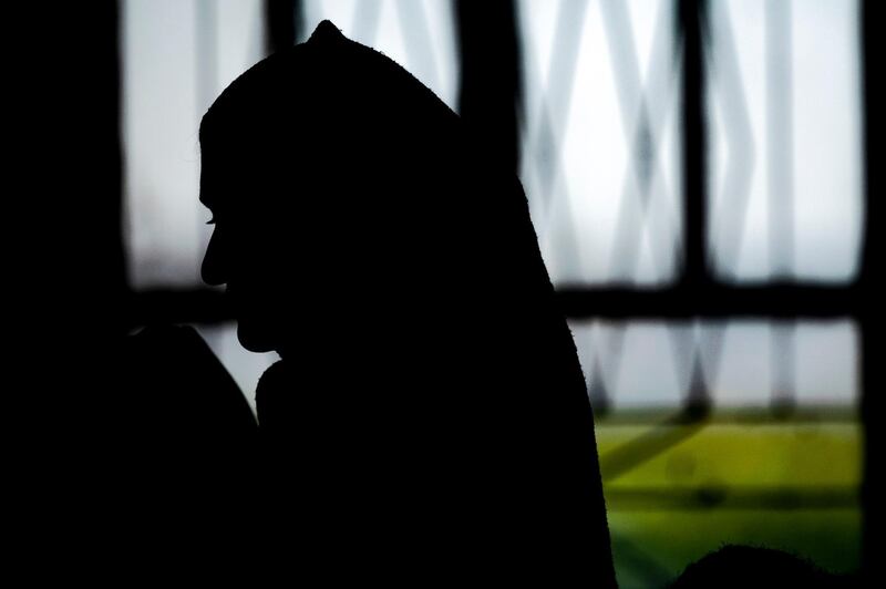 This picture taken on April 13, 2019 at the Syrian Kurdish-run group Yazidi House's headquarters in the Syrian Yazidi village of Qizlajokh, about 35 kilometres west of Qamishli in the northeastern Hasake province, shows an Iraqi Yazidi woman rescued from the Islamic State (IS) group waiting to board buses bound for Sinjar in Iraq's Yazidi heartland. Syrian Kurds on April 13 repatriated 25 women and children from Iraq's Yazidi minority after freeing them during the final push against the Islamic State group, said an official with Yazidi House, which reunites rescued Yazidi children with surviving relatives. Iraq's Yazidis are a symbol of the suffering caused by IS during its rein over vast swathes of Syria and Iraq.  / AFP / Delil SOULEIMAN
