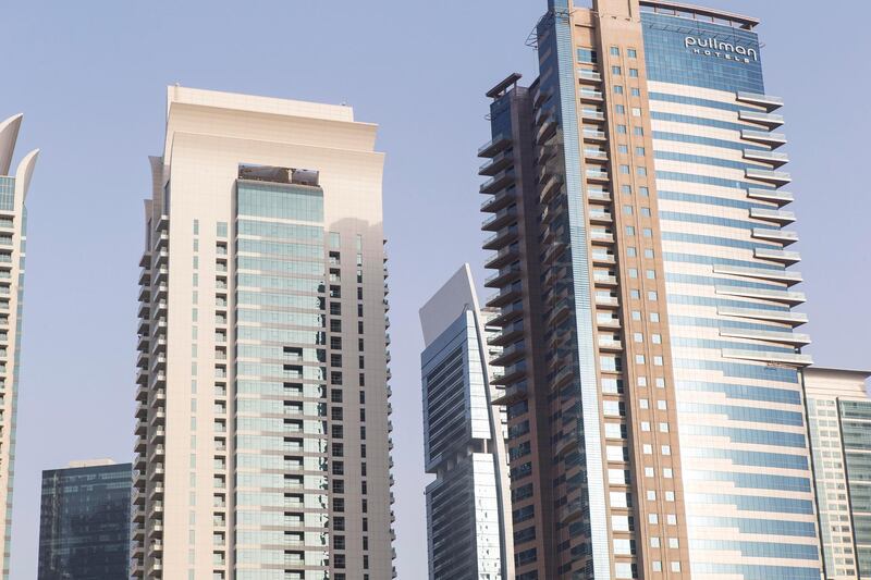 DUBAI, UNITED ARAB EMIRATES, 15 JULY 2015. Apartment buildings on Sheikh Zayed Road in the JLT (Jumeirah Lakes Towers) neighbourhood of Dubai. The Pullman Hotel is to the right. Property, Rents, Apartments, Rental, Tower, Skyscraper. (Photo: Antonie Robertson/The National) Journalist: Stock. Section: Business. *** Local Caption ***  AR_1607_Apartment_Stock-04.JPG