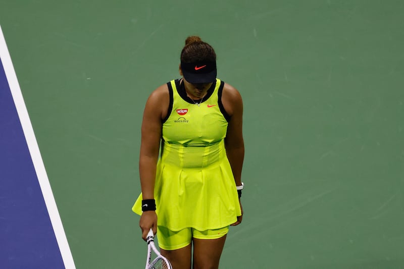 Naomi Osaka of Japan walks with her head down after losing a point.  EPA