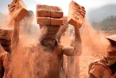 Workers in Nepal stack bricks on their heads, up to 18 at a time. Each brick weighs more than a kilogram Photo by Lisa Kristine