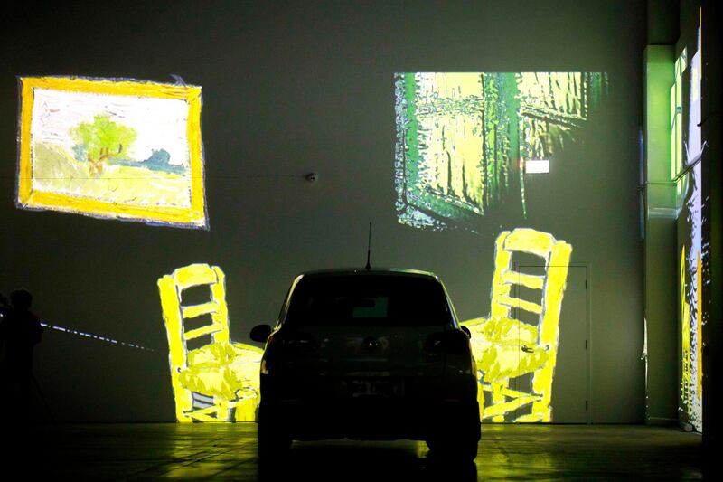 People sit in their cars as they experience a drive-in immersive Vincent Van Gogh art exhibit in Toronto, Ontario. AFP