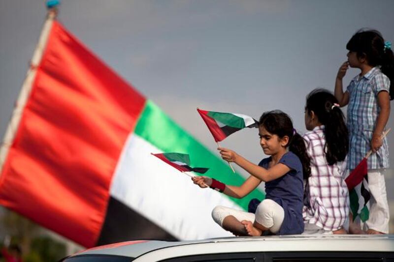 Abu Dhabi, United Arab Emirates, December 02, 2012:  
Children from the al Marzouqi family from Abu Dhabi join in as people celebrate the 41st UAE National Day on Sunday, Dec. 2, 2012, during the Union Car Parade on the Yas Island near Abu Dhabi.  Silvia Razgova / The National


