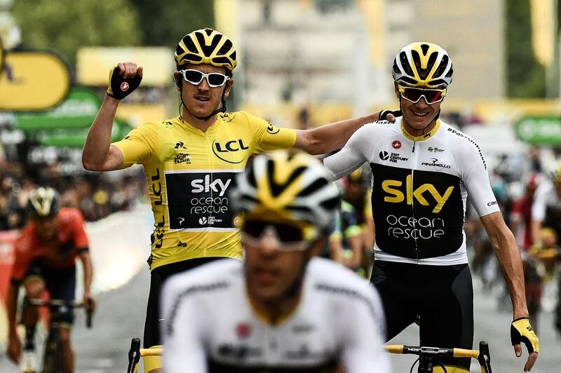 (FILES) In this file photograph taken on July 29, 2018, Tour de France winner Great Britain's Geraint Thomas (L) wearing the overall leader's yellow jersey and classification third-placed Great Britain's Christopher Froome (C) react as they cross the fisnish line of 21st and last stage of the 105th edition of the Tour de France cycling race between Houilles and Paris Champs-Elysees. Four-time Tour de France champion Chris Froome will not get the chance to end his spell with Team Ineos Grenadier with a tilt at a fifth crown after being omitted from the team for this year's race. The 35-year-old Kenyan-born British rider "needs more time" according to team principal Dave Brailsford and will instead aim for the Vuelta d'Espana, AFP learnt on August 19, 2020. Brailsford has also left out 2018 champion Geraint Thomas who will target the Giro d'Italia. / AFP / Philippe LOPEZ
