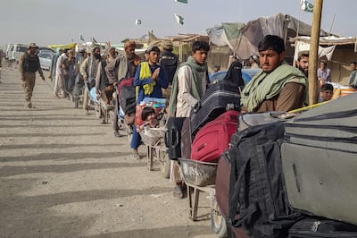Afghan nationals queue at the Pakistan-Afghanistan border crossing point in Chaman to return back to Afghanistan. AFP