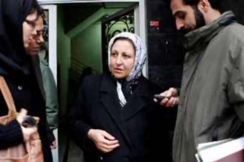 epa01583299 Iranian Nobel peace laureate Shirin Ebadi (C) and her colleagues stand in front of their office in Tehran, Iran, 21 December 2008. Iranian police on 21 December closed and sealed-off the office of Ebadi in Tehran which was used a Human Rights Centre. The police went to the office, used by a human rights group headed by Ebadi, called on the staff to leave and then sealed it off. According to the Tehran prosecutor office the closure was because the centre had no legal permit for its activities.  EPA/STRINGER *** Local Caption ***  01583299.jpg