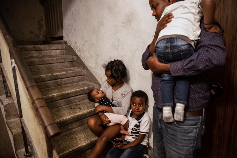 Eritrean asylum seeker Kahase Gerensae and his children take shelter in the stairwell outside their apartment in Ashdod, Israel, during a siren warning of rockets fired from the Gaza Strip. AP Photo