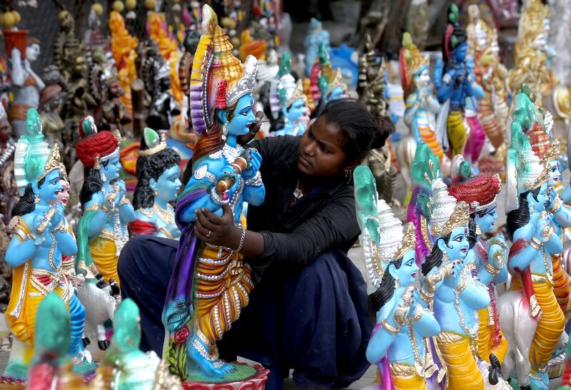 A street vendor puts finishing touches to an idol of Hindu god Krishna before Janmashtami celebrations in Bangalore, India. EPA 