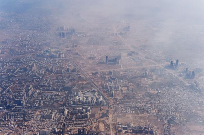 Smog envelops buildings on the outskirts of the Indian capital New Delhi.  Roberto Schmidt / AFP