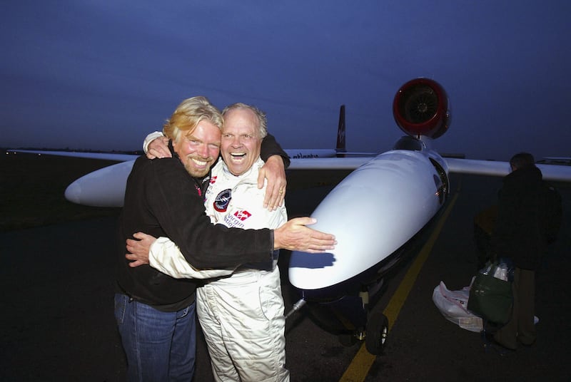 Steve Fossett is hugged by Sir Richard Branson in Bournemouth, England, after making an unscheduled landing due to electrical problems with the Virgin Atlantic GlobalFlyer aircraft in 2006.