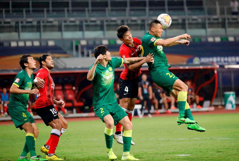 Beijing Guoan's Yu Dabao, right, fights for the ball with Wang Shenchao of Shanghai SIPG. AFP