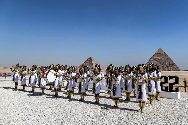 Marching band members dressed in ancient Egyptian clothing.