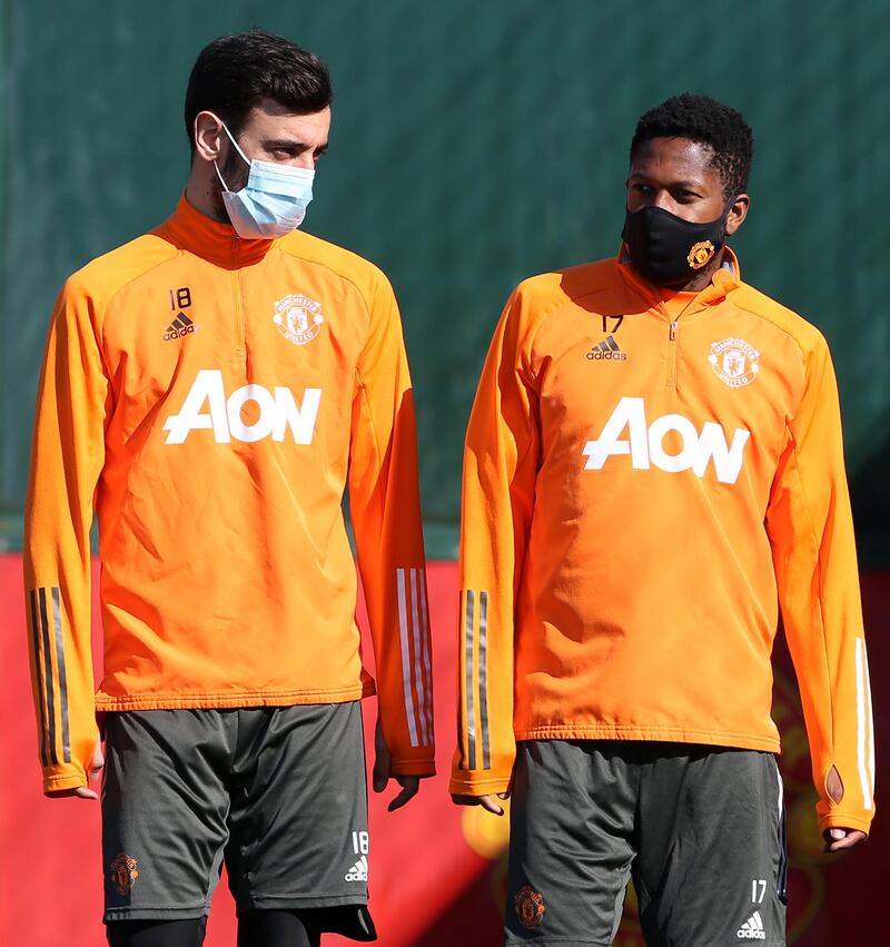 MANCHESTER, ENGLAND - APRIL 02:  Bruno Fernandes of Manchester United chats to Fred during a first team training session at Aon Training Complex on April 2, 2021 in Manchester, England. (Photo by Matthew Peters/Manchester United via Getty Images)