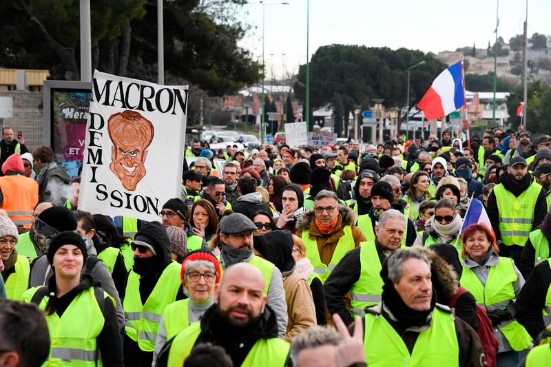 Protesters wearing yellow vests walk in a street of Beziers, southern France, during an anti-government demonstration called by the Yellow Vest movement on January 19, 2019.  'Yellow vest' protesters take to the streets on January 19 for 10th consecutive Saturday. / AFP / Pascal GUYOT
