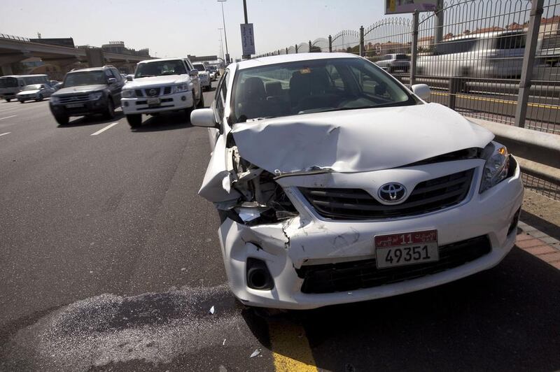A car involved in an accident on the side of Sheikh Zayed Road. Some insurers give discounts to accident-free clients. Christopher Pike / The National