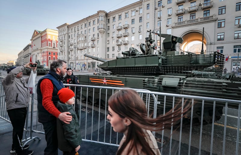 Muscovites watch Russian heavy weapons make their way to Red Square. EPA