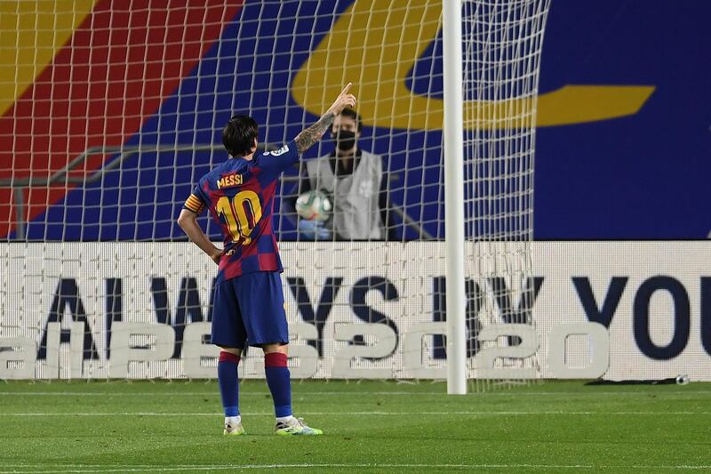 Lionel Messi celebrates towards the empty stands after scoring Barcelona's second goal. Getty Images