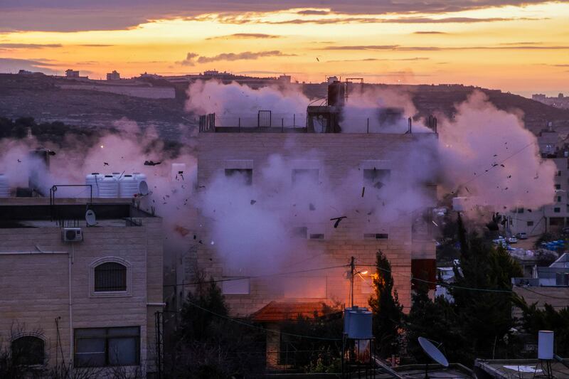 A controlled explosion by Israeli forces destroys the home of Mohammad Kamal Jabari. AFP