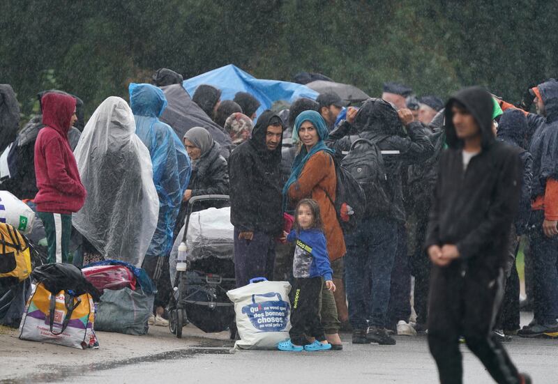 A group of people thought to be migrants in Grande-Synthe, northern France after French police dismantled their camp clearing their tents and shelters. PA