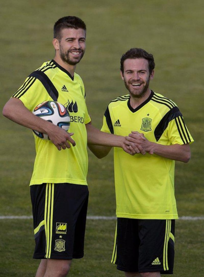 Spain defender Gerard Pique, left, and midfielder Juan Mata, right, at Monday's training session ahead of the 2014 World Cup. Dani Pozo / AFP / May 26, 2014