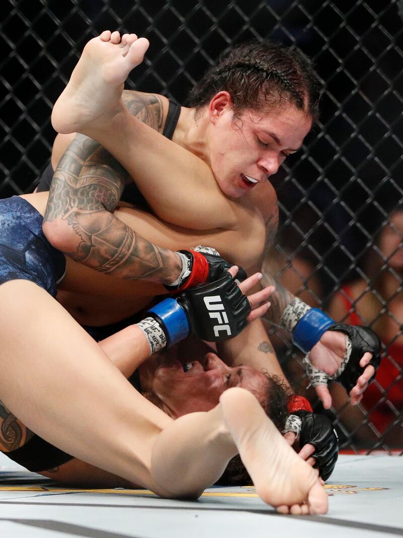 Amanda Nunes, top, fights Germaine de Randamie. AP