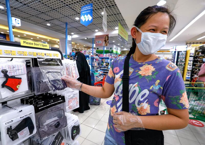 Abu Dhabi, United Arab Emirates, July 30, 2020.   
An Eid shopper looks at some face masks at Lulu Hypermarket, Khalidiyah Mall.
Victor Besa  / The National
Section: NA
For:  Standalone/Stock Images