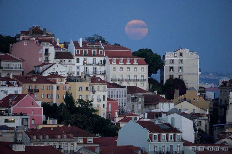 The full moon rises over Lisbon, Portugal, on May 5, 2023. AP