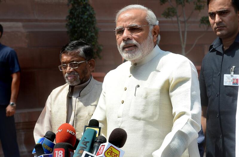 Indian PM Narendra Modi addresses the media upon his arrival for the first session of India's newly elected parliament in New Delhi on June 4, 2014. AFP Photo