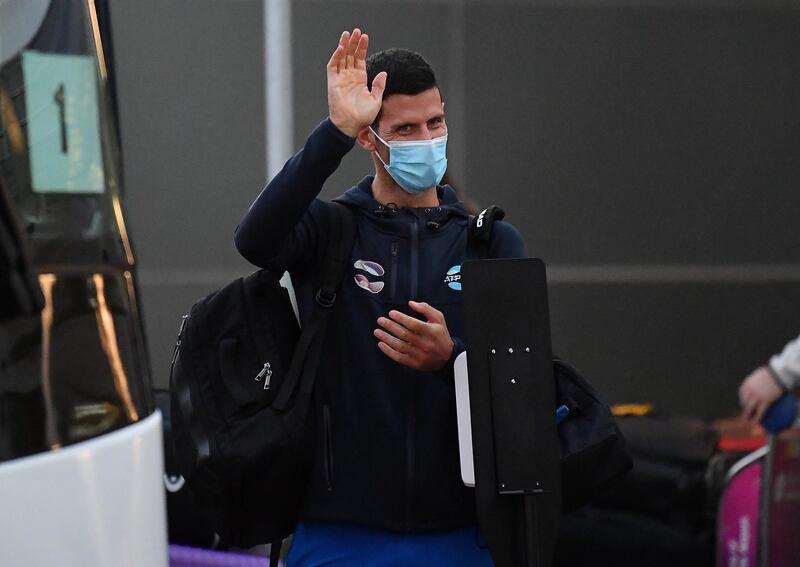 Novak Djokovic waves as he  arrives at Adelaide Airport on January 14 ahead of the Australian Open. All players and staff must complete 14 days of hotel quarantine before being able to compete in the Grand Slam and warm-up events. Getty