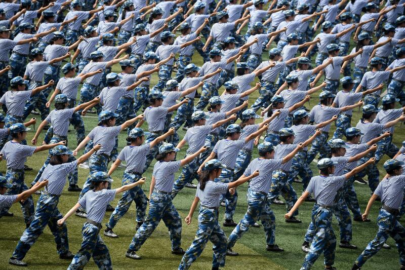 Female students hold fake knives during a military training in Wuhan, Hubei, China. Reuters