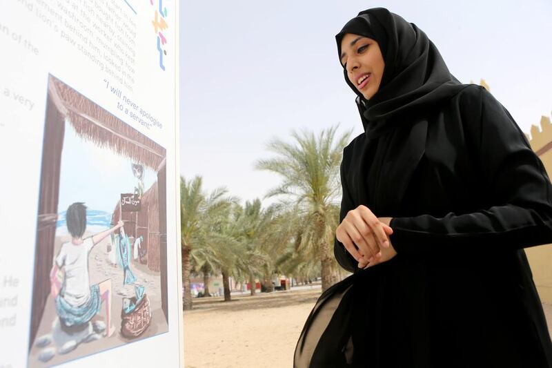 Illustrator Khawla Al Marzouqi next to the storyboard she drew for Mansor and Abu Ras for the Story Mile in Khalifa Park in Abu Dhabi. Sammy Dallal / The National
