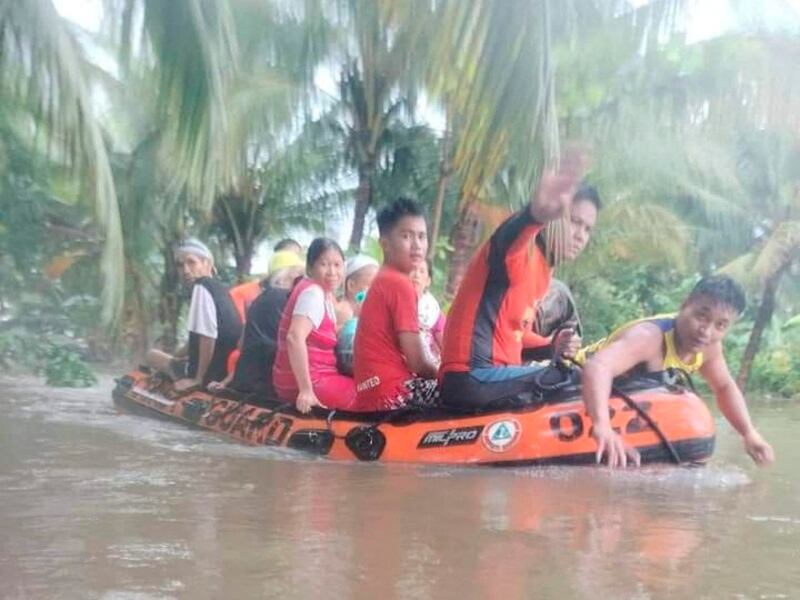 Residents are evacuated by dinghy from their flooded homes in Sultan Kudarat province on Friday. Reuters