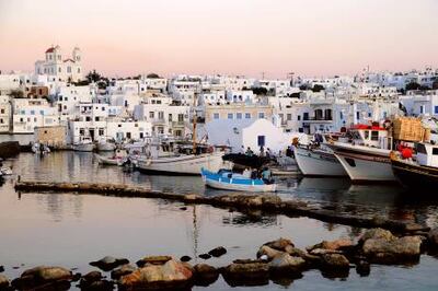 Boats at harbour in the afterglow, Naoussa, island of Paros, the Cyclades, Greece, Europe (Photolibrary.com)
