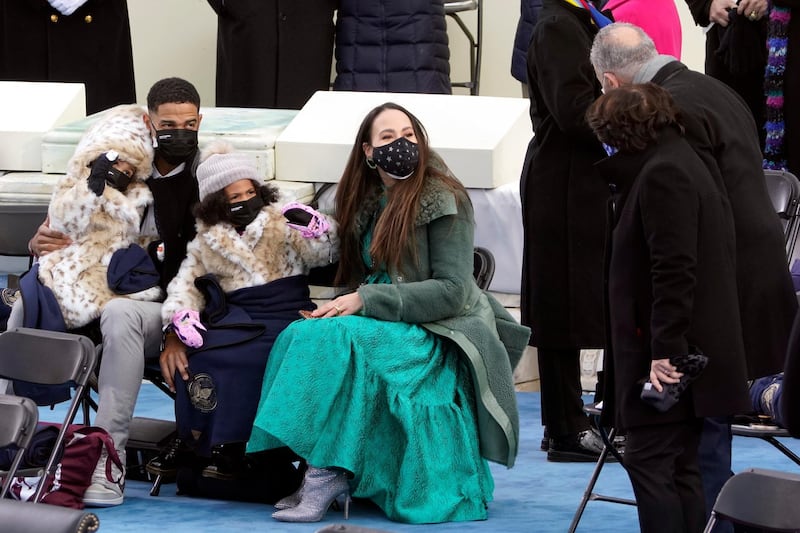 Members of Kamala Harris's family talk with New York Senator Chuck Schumer during the inauguration. AP