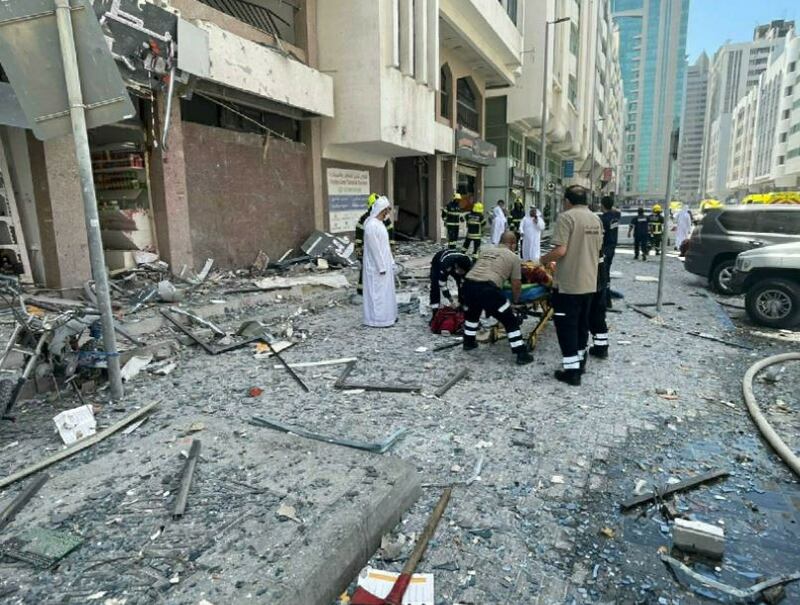 Emergency crews help the injured outside a block of flats. Photo: Abu Dhabi Police