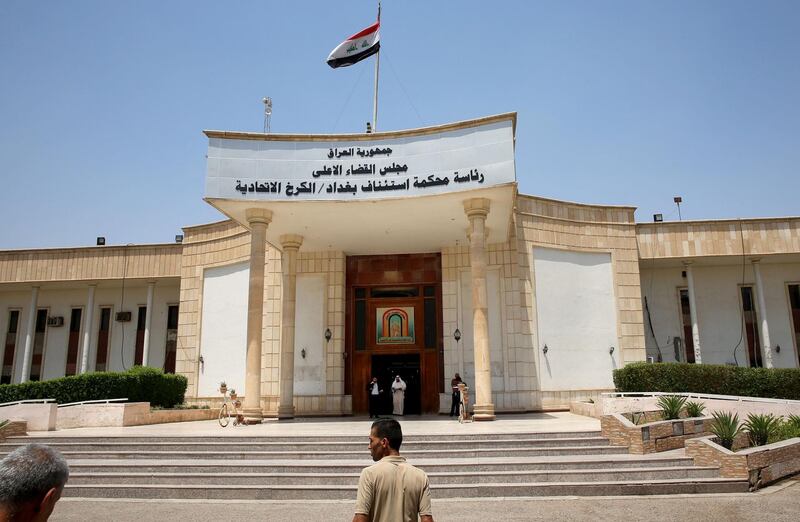 Men walk out of Baghdad's Karkh main appeals court building in the western sector of the Iraqi capital on May 29, 2019 where French jihadists accused of belonging to the Islamic state are being tried. The Baghdad court sentenced a Frenchman to death for joining the Islamic State group, bringing to seven the number of French jihadists on death row in Iraq. / AFP / SABAH ARAR
