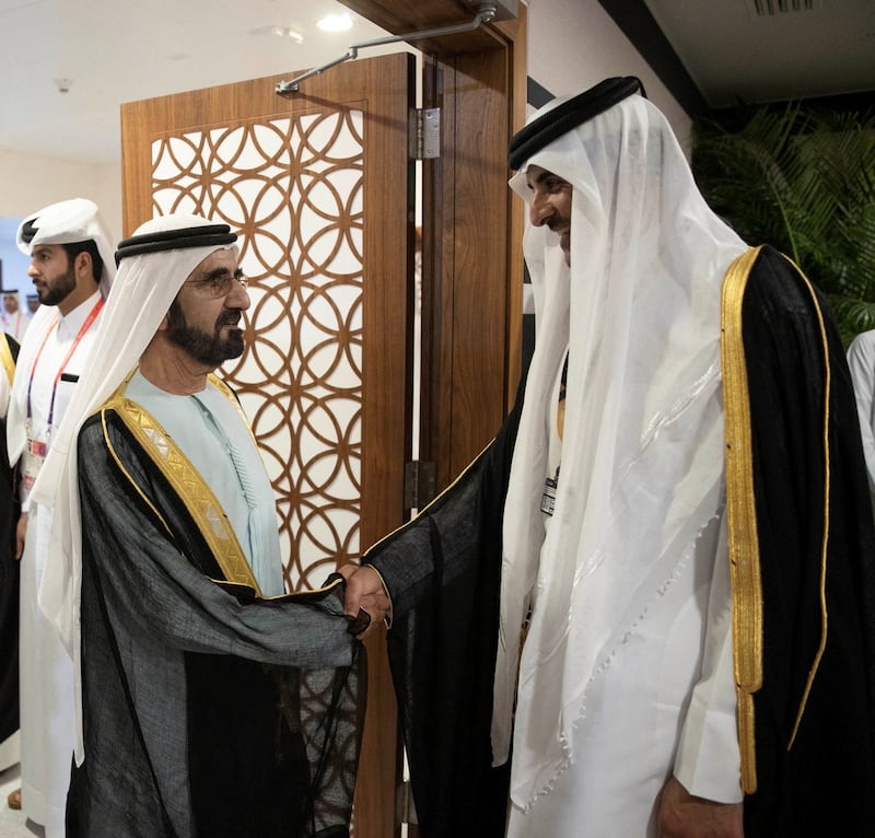 Sheikh Mohammed shakes hands with Sheikh Tamim on the sidelines of the World Cup in Doha. Qatar News Agency via Reuters