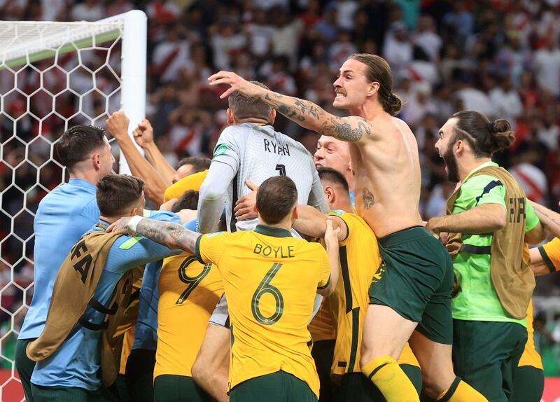 Australia's Andrew Redmayne and teammates celebrate after qualifying for the 2022 World Cup. Reuters