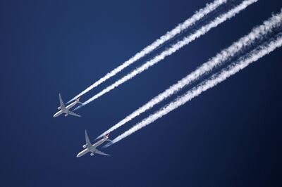 LONDON, ENGLAND - MARCH 12:  Two commercial airliners appear to fly close together as the pass over London on March 12, 2012 in London, England.  (Photo by Dan Kitwood/Getty Images)