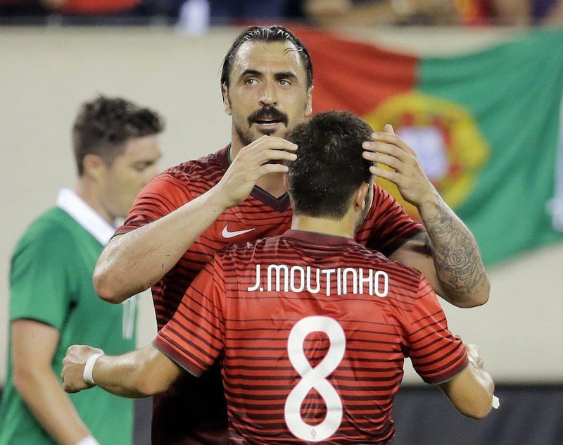 Portugal's Hugo Almeida celebrates with Portugal midfielder Joao Moutinho after Almeida scores against Ireland in the first half of their international friendly on Tuesday ahead of the 2014 World Cup in Brazil. Ray Stubblebine / Reuters / June 10, 2014