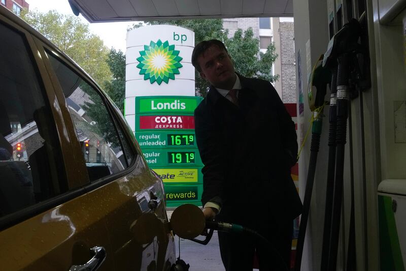 A man fills his car with petrol at a BP station in London. AP
