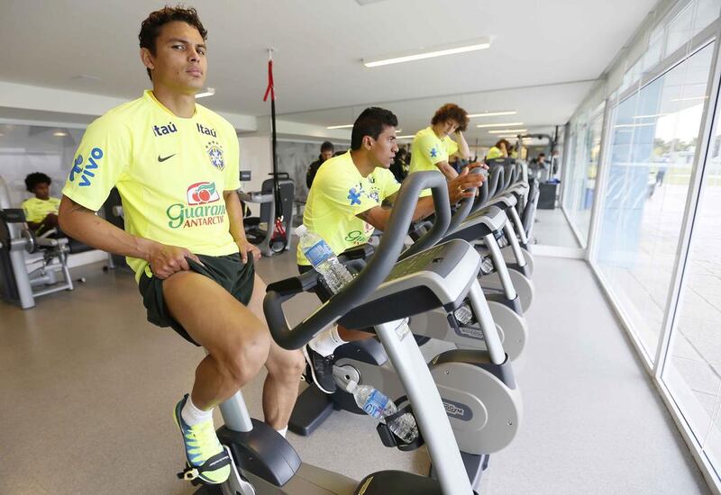 Brazil's Thiago Silva, left, is pictured next to teammates Paulinho, centre, and David Luiz during a physical test on Tuesday as Brazil prepare for the 2014 World Cup. Rafael Ribeiro / CBF / Reuters / May 27, 2014