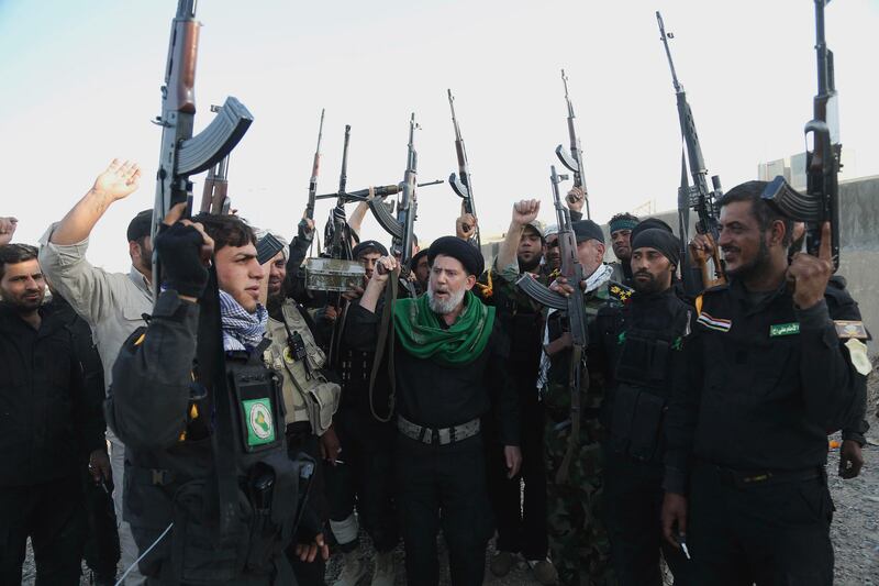 Iraqi Shiite militia groups chant slogans against ISIS in Tikrit, 130km north of Baghdad. AP 
